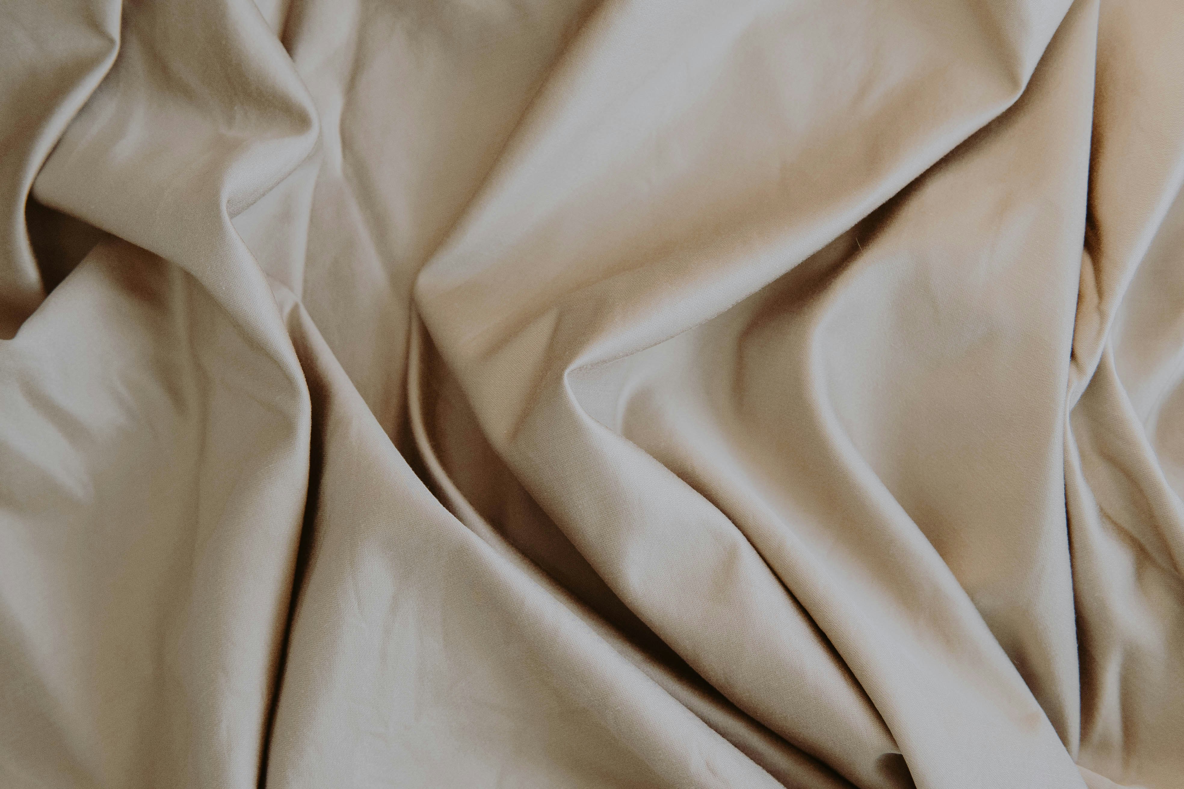 white textile on brown wooden table